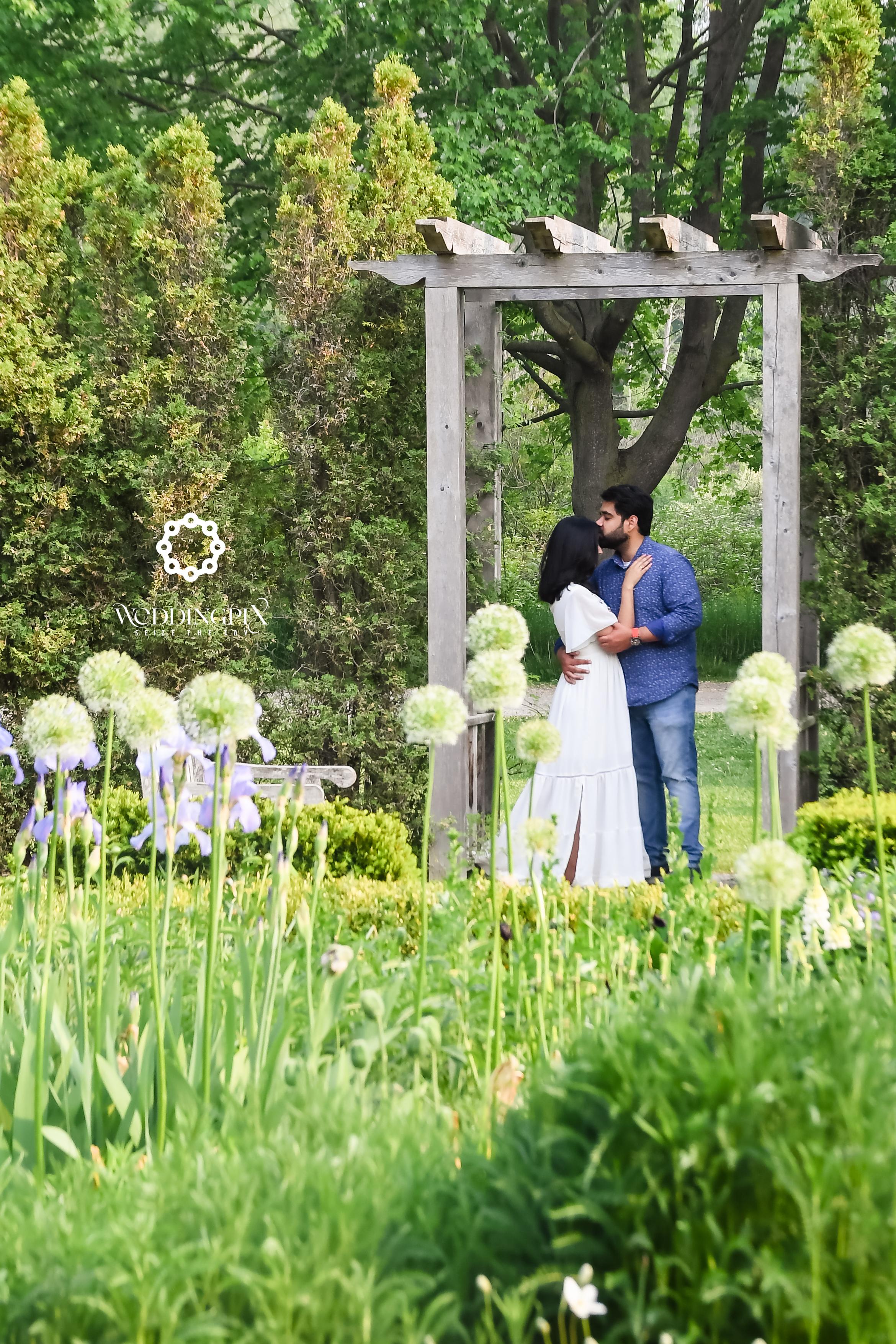 Engagement photo shoot in beautiful flower garden.